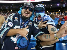 Argonauts fans John Granger (left), and Jamie Wolodarsky cheer for their team prior to the start of the Grey Cup game at the Rogers Centre in Toronto, Ont., Nov. 25, 2012. (CHRISTINNE MUSCHI/Reuters)