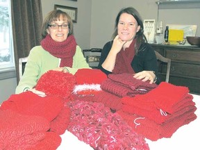 RAISING AWARENESS
DONAL O'CONNOR The Beacon Herald
Anne Dixon-Mahatoo, left, and Laurie Krempien-Hall show some of the knitted scarves they will be giving away Tuesday to raise awareness about HIV/AIDS.