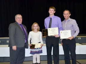 (L. to R.) Tisdale Mayor Al Jellicoe, MacKenzie Johnson, Ty Pederson and coach Harvey Webber. the athletes and coach were presented with awards at the Town of Tisdale Recognition Night on November 21.