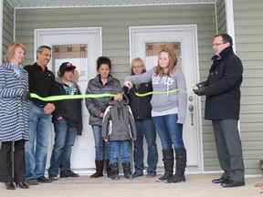 The official ribbon cutting means the end of the work and the start of a new chapter in the lives of the two families moving into the duplex.
