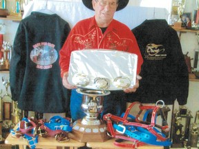 Louis Johner poses with just some of the prizes he won during the 2012 chuckwagon and chariot racing season.