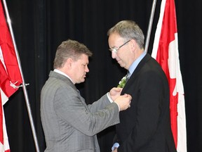 MP Randy Hoback (left) presented Rod Gantefoer with a medal.