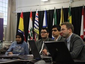 Haiqa Cheema, Abraham Alamouie, Ali-Reza Salehi and teacher Terry Godwaldt video-conference with Senator Grant Mitchell and students across Canada at Queen Elizabeth School last week. DALE BOYD/SPECIAL TO THE EXAMINER