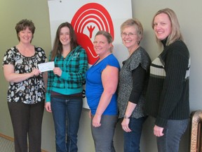 Kathee Thurston, president of the Portage Plains United Way, accepts a cheque for $1,300 from Child and Family Services of Central Manitoba staff Olivia Decaire, Sara Murray, Leta Maksymyk, and Leigh Campbell. The funds were raised from a garage sale held at the Legion earlier this year. (SUBMITTED PHOTO)