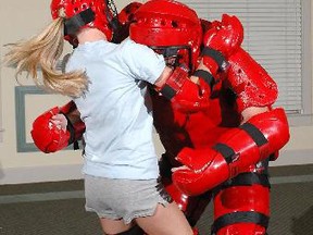 A Wilfrid Laurier University student practices self-defence techniques against an armoured member of Laurier Brantford's special constable service during an on-campus class. SUPPLIED PHOTO