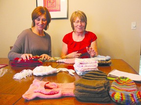 Emma Elliott, right, and her daughter Yvonne Westcott look over some of the items Elliott has knitted.