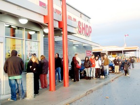 Customers line up for Black Friday sales. BOB BOUGHNER/QMI Media