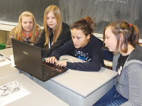 STEPHEN UHLER    St. James Catholic School students (from left) Alanna Brasch, Jasmine Passendawatch, Meiyah Brooks-Whiteduck and Cassidy Dashnay keep track of their virtual business as their Grade 7/8 class take part in the GoVenture Micro Business workshop.