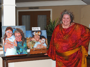 Jacquie Paul of Rochfort Bridge may be better known for her work as a face painter but she also works in a number of media. Here Paul poses with some of her art work that was part of an art show at the Pleasant Valley Lodge in Mayerthorpe on Nov. 8.