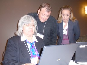 Marilyn Cook works on the London-Middlesex newcomer portal during a
two-day conference in Chatham, On. which began Tuesday at the John D. Bradley Convention Centre. Looking on are David Wood, project lead, and Audrey Ansell, Chatham-Kent's co-ordinator of youth retention and immigration.