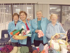 Joyce Garnett, Sylvia Dozy, Hannah Young and Mary Walters pose with beautiful knit-ware which was for sale at the Saugeen Memorial Hospital Auxiliary's Christmas Bazaar.