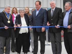 Local dignitaries were on hand Friday as Theresa VandenBussche, president of VandenBussche Irrigation & Equipment, cut the ribbon on a $1.5-million expansion at the company’s head office on the south side of Delhi. At left is Norfolk Mayor Dennis Travale while at right are company manager Marc VandenBussche, local MPP Toby Barrett and Delhi Coun. Mike Columbus. (MONTE SONNENBERG Delhi News-Record)