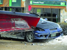 Portage Emergency Services responded to a collision at 1st St. SW and Saskatchewan Ave., Tuesday, after a grader collided with a car. (ROBIN DUDGEON/THE DAILY GRAPHIC/QMI AGENCY)