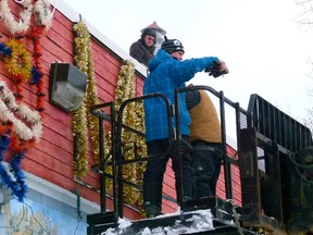 Fairview Rotary Members were putting up Christmas decorations on the old Fire Hall, Lenny Basnett up on the roof, Ken Thompson signalling to Perry Wild (not in photo) on the manlift while volunteer Keith Lyons finishes fastening a bolt securing the letters they were putting up.
CHRIS EAKIN/FAIRVIEW POST/QMI AGENCY