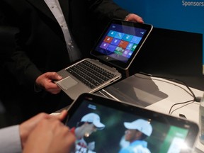 Attendees look over a Hewlett-Packard computer tablet that features Intel Corp's latest "Atom" processor and Windows 8 software, in San Francisco, California September 27, 2012. (Reuters/ROBERT GALBRAITH)