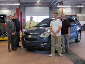 Craig Dunn pictured with Sean Benediction, vice principal Bob Kriski, Jon Elliott, and Leo Lanouette at the auto shop at Portage Collegiate. Dunn donated a 2012 Chevy Equinox to the auto mechanics course to allow them to learn with the latest technologies. (ROBIN DUDGEON/THE DAILY GRAPHIC/QMI AGENCY)
