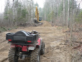 C-108-D snowmobile trail is having a re-route around the Espanola Light Industrial Park expansion. Seen here is a Espanola District Snowmobile Club volunteer and a town employee ensuring the culverts are installed properly.  Photo supplied.