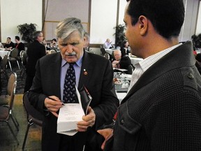 Senator Romeo Dallaire autographs a copy of his book Shake Hands with the Devil, an account of the Rwandan genocide. Dallaire says military families now share the stress of deployments.
Elliot Ferguson The Whig-Standard