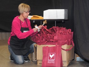 Jayne Middleton, manager at the Grande Prairie Farmers Market, packs gift bags for the upcoming Grande Prairie Farmers’ Market Christmas Craft Show and Sale. (Patrick Callan/Daily Herald-Tribune)
