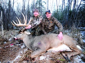 After weeks of patience, Dennis Chevalier, left, dropped this monster buck last week. Along with partner Chris Savage, the pair have been scouting the white tail deer for most of the 2012 season.
JEFF GUSTAFSON/Daily Miner and News