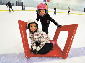 Six-year-old Caroline Macleod gives her friend Ruby Nylund, 6, a ride around the rink on Friday, Nov. 23 during the Fenlands Rec Centre's public skate from 7:15-10 p.m. Those who are 18 years old and under skate for free. CORRIE DIMANNO/BANFF CRAG & CANYON/QMI AGENCY