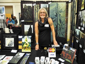 Artist and owner of Silly Goat Studio Lynne Huras meets and greets market goers from behind her booth during the the 17th annual Canmore Christmas Artisans Market at Canmore Collegiate High School in 2012. The market returns this weekend as does a new holiday market in Banff that will run at Warner Stables.Crag & Canyon file photo