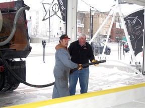 Tourism Kenora’s Mark Duggan (right) gets a helping hand from Kirk James of C.J. Edwards Ltd. in flooding the new rink at the Whitecap Pavilion, Wednesday morning. Constructed with donations of cash, materials and labour by several local groups and businesses, Duggan says the rink will open to public skating night and day during the winter once the ice sets.
REG CLAYTON/Daily Miner and News