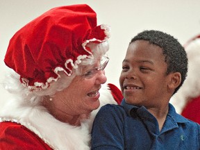 Five-year-old Keishaun Moxley of Brantford shares a chuckle with Mrs. Claus on Sunday afternoon during a Christmas party at the Lansdowne Children's Centre in Brantford. BRIAN THOMPSON/QMI AGENCY