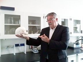 Brant MPP Dave Levac riffs on Shakespeare with a skull at the opening of Laurier Brantford's new science labs. OREN WEINER/FOR YOUR BRANT CONNECTION