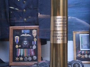 KEVIN RUSHWORTH PHOTO. The Pincher Creek Legion time capsule, in the form of an 85 mm shell, will be locked away into the display case to be opened in 15 years, the 100th anniversary of the Pincher Creek Legion.