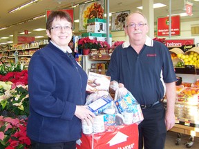 Patsy Timmer and her husband Martin Timmers, owners of Foodland in Ingleside, stand with food which has been donated to the Osnabrook Food and Toy Drive. Foodland and other stores in the plaza are raising money, toys and non-perishable food items for less fortunate people in time for Christmas.
Staff photo/ERIKA GLASBERG