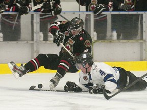 London Nationals defenceman Shawn Crowley, right, and Sarnia Legionnaires defenceman Matt Cimetta both fall to the ice while battling for the puck during their GOJHL game at the Western Fair Sports Centre on Wednesday. (CRAIG GLOVER, The London Free Press)