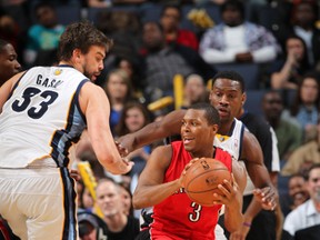 Raptors' Kyle Lowry looks to pass the ball against Marc Gasol (left) and Tony Allen of the Grizzlies on Wednesday night in Memphis. (Getty Images/Files)