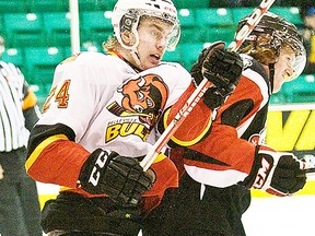 Belleville Bulls forward, Garrett Hooey, mixes it up near the Niagara Ice Dogs net during OHL action Wednesday night at Yardmen Arena. (Don Carr for The Intelligencer.)