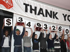 Students at the United Way's touchdown breakfast at the Ambassador hotel Thursday morning hold up the final amount raised during the 2012 campaign.
Michael Lea The Whig-Standard