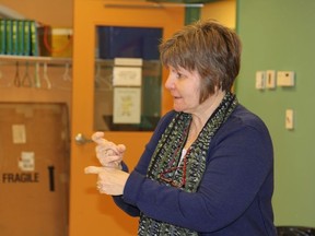 Carolyn Courville is teaching sign language to Cochranites for free. Here she is showing the the sign for “right” as in “correct.”