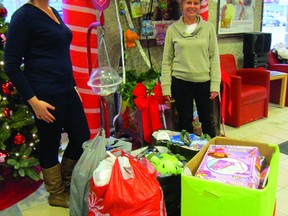 Teachers Kaitlyn McDermid and Crystal Wilson stand with the $500 worth of toys they donated to the Scotia Bank/Salvation Army Toy Mountain campaign, Thursday. The students from Agassiz Youth Centre had a bake sale where they raised the funds, which they wanted to donate to the campaign. (ROBIN DUDGEON/THE DAILY GRAPHIC/QMI AGENCY)
