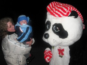 Lyn Stewart and her grandson Emerson met a Christmas panda during Panorama in Simcoe in 2011. The Stewart family from Guelph has visited the annual Christmas light displays for more than 30 years. (Contributed Photo)