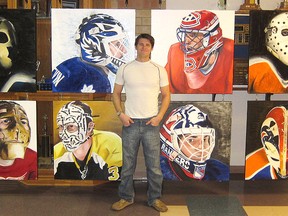 Sarnia artist Michael Slotwinski stands in front of some of the oil paintings of famous hockey goalies and their masks which he will be bringing to the K-Rock Centre for Friday night's Kingston Frontenacs' game.