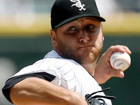 Starting pitcher Mark Buehrle of the Chicago White Sox throws a pitch against the the New York Yankees during their MLB American League baseball game in Chicago, Illinois in this August 2, 2009 file photo. The former White Sox and Miami Marlins pitcher was part of a multi-player blockbuster trade with the Toronto Blue Jays on Nov. 13, 2012. (JEFF HAYNES/Reuters)