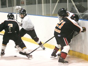 CHRISTOPHER SMITH, The Expositor

North Park and Pauline Johnson players battle along the boards during a high school boys hockey game at the Wayne Gretzky Sports Centre on Thursday. North Park won 5-0.