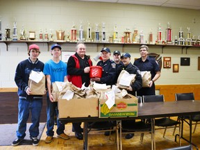 Pictured (left to right) Taylor Deroos, Travis Murray, Ed Giles, Lorne Currie, Peter Eagleson, Adami Shular and Ian MacAulay pose with a small portion of the 200 plus bags of food collected from the food drive.
