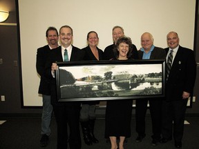 Devon town council posed with a framed portrait of Grimma, Germany’s Poppelmann Bridge, which was given to council as a gift by the German city last month.
From left, councillors Dan Woodcock, Michael Laveck, Sheila Aitken and Ray Ralph, Mayor Anita Fisher and councillors Grant Geldart and Gordon Groat.