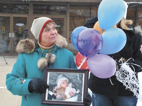 Marilyn Koren of Warburg commemorates her granddaughter Delonna Sullivan’s life at a protest outside the Leduc Provincial Courthouse Nov. 23.