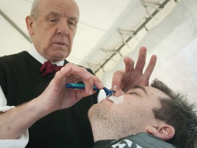 Dustin Reinders loses his Movember moustache at the hands of barber Walter Payne during a fundraising event at David E. White on Queens Avenue in London on Friday November 30, 2012.  The event was one last push to raise funds for Movember, a worldwide movement that raises money for research and awareness of prostate cancer.
(CRAIG GLOVER, The London Free Press)