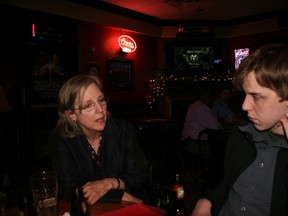 Liberal leadership hopeful Deborah Coyne speaks with Dylan Ashley, the youth leader for the Liberal's Fort McMurray-Athabasca Riding Association, on Thursday night at Longshots. Coyne was in torn to promote her bid for leadership, as well as her views on Canada's energy industry and the environment.