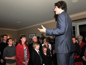 Liberal leadership hopeful Justin Trudeau stands on a coffee table to address a crowd of party faithful at the Brockville home of Dr. Andy and Sharon Jordan on November 28.
(NICK GARDINER The Recorder and Times)