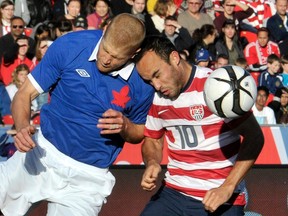 Canada's Andre Hainault (left) jumps for a header against Landon Donovan of the U.S. during a June friendly in Toronto. Hainault will try to hoist the MLS Cup today as a member of the Houston Dynamo. (REUTERS/FILES)
