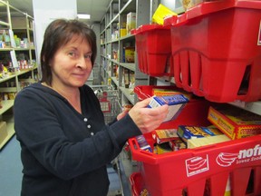 April Johnston, a member of the St. Vincent de Paul Help Centre in Sarnia, checks a bin in the food bank, gearing up for the annual Christmas hamper project. Food collected during Saturday's Irish Miracle will help St Vincent de Paul fill its share of hampers being distributed in the city this year. PAUL MORDEN/THE OBSERVER/QMI AGENCY