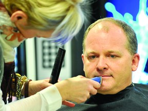 Brockville and Area YMCA board chairman Jim Cooper gets his Movember moustache clipped by Linn Rylands of Elite Spa – an exercise he eagerly anticipated every day for a month (DARCY CHEEK/The Recorder and Times).